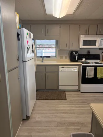 a kitchen with stainless steel appliances a refrigerator sink and microwave