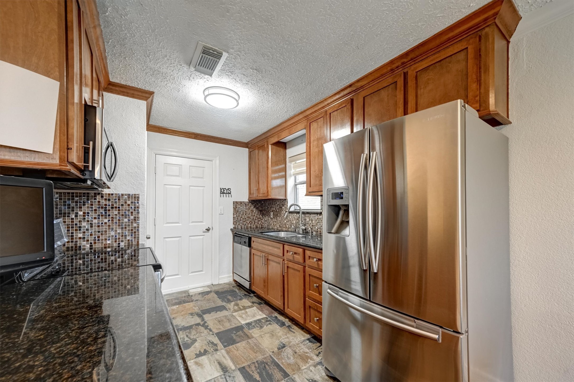 10118 Fernstone Lane Houston, TX 77070 - Photo 3 of 11 a kitchen with stainless steel appliances granite countertop a refrigerator and a stove