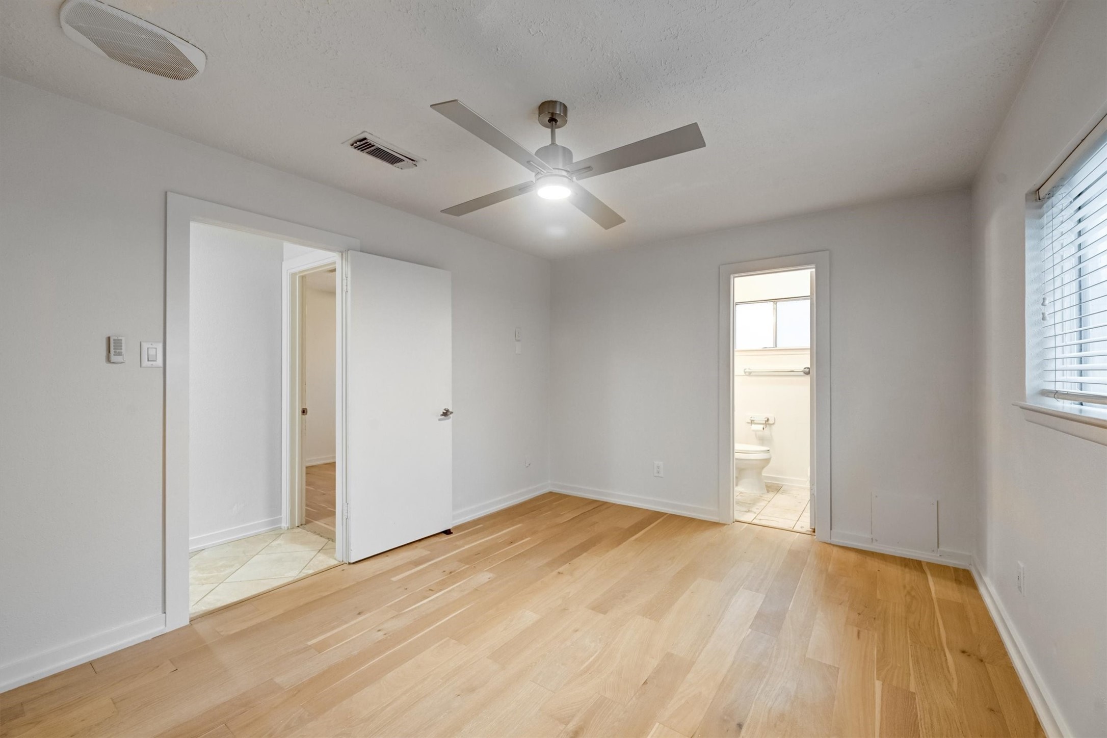 10118 Fernstone Lane Houston, TX 77070 - Photo 8 of 11 a view of empty room with wooden floor and fan