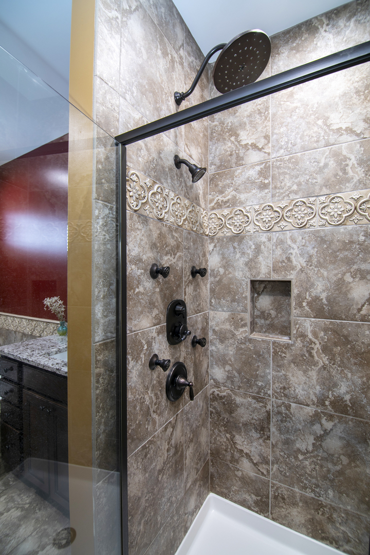 16665 Merc Lane Lockport, IL 60441 - Photo 28 of 54 a bathroom with a shower and vanity