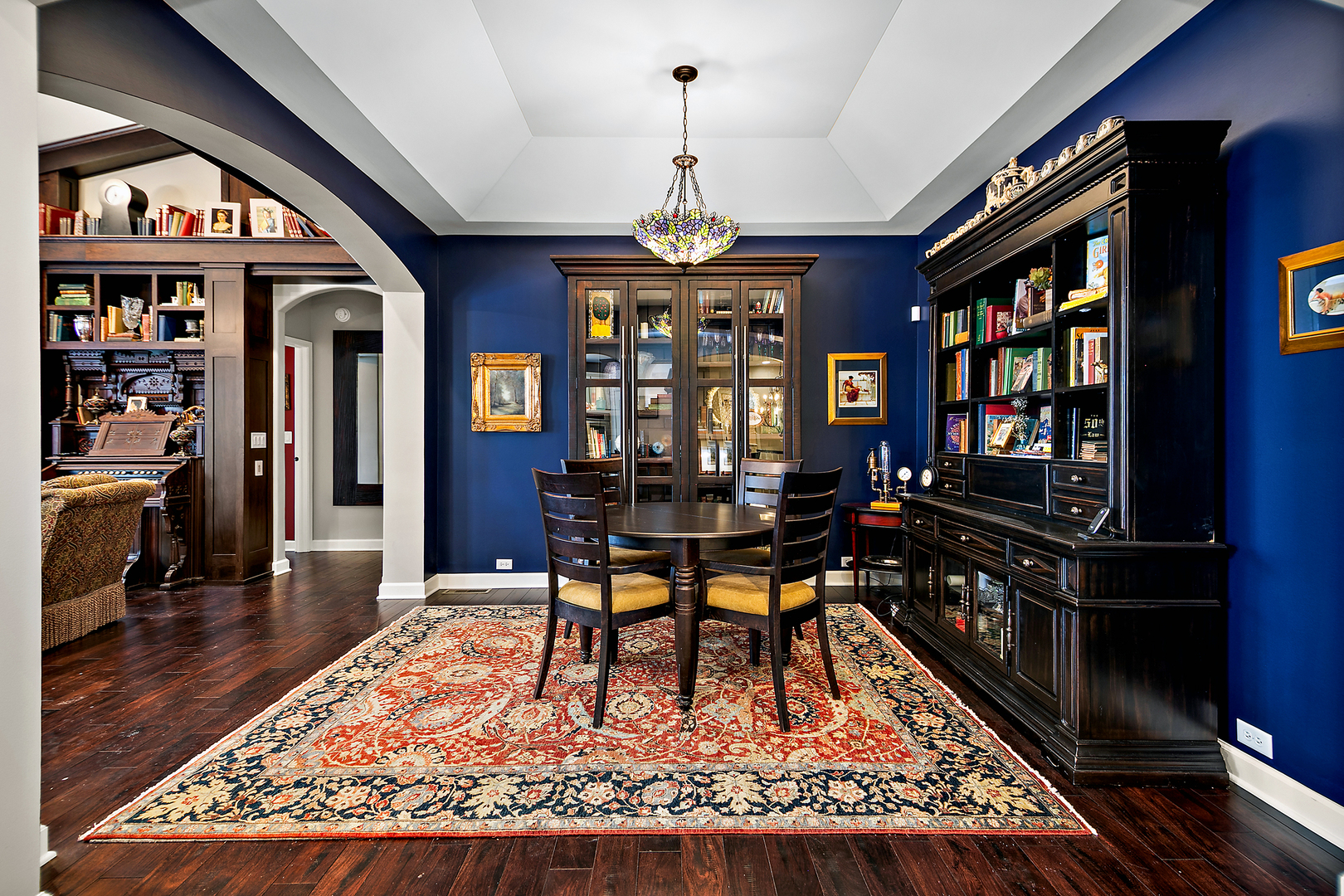 16665 Merc Lane Lockport, IL 60441 - Photo 6 of 54 a dining room with wooden floor a chandelier a wooden table and chairs
