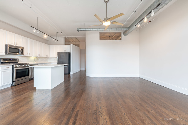 1000 West Adams Street, Unit 413 Chicago, IL 60607 - Photo 15 of 29 a view of kitchen with stainless steel appliances wooden floor and a window