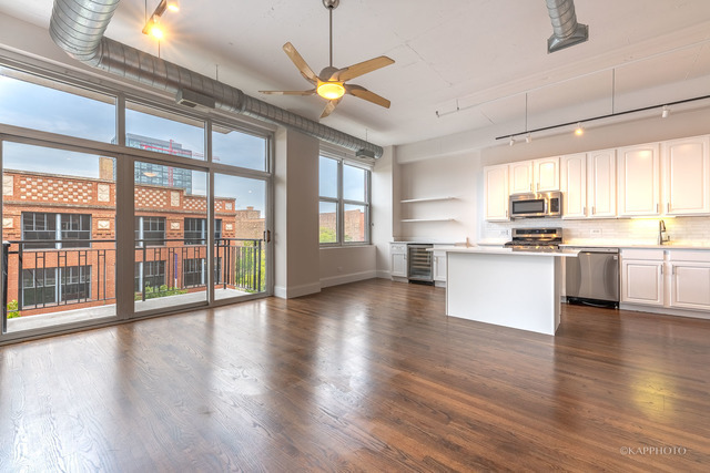1000 West Adams Street, Unit 413 Chicago, IL 60607 - Photo 7 of 29 a view of a kitchen with a stove cabinets and wooden floor
