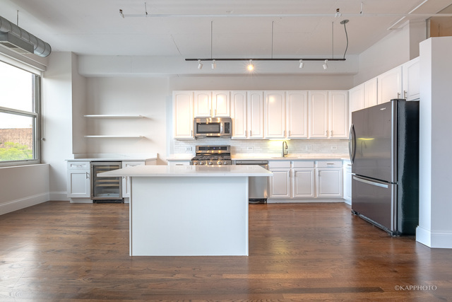 1000 West Adams Street, Unit 413 Chicago, IL 60607 - Photo 9 of 29 a kitchen with a refrigerator and a sink