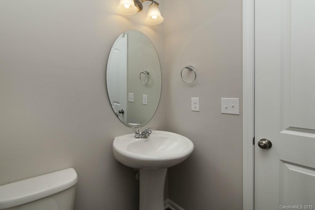 79475 Ridgehaven Road, Unit 43 Lancaster, SC 29720 - Photo 11 of 21 a bathroom with a sink a mirror and toilet