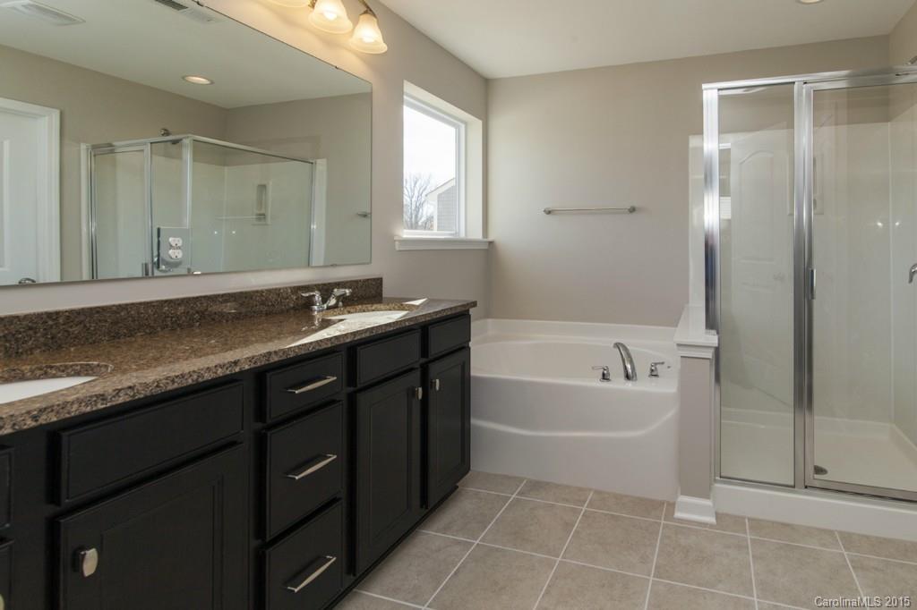 79475 Ridgehaven Road, Unit 43 Lancaster, SC 29720 - Photo 14 of 21 a spacious bathroom with a tub sink and mirror