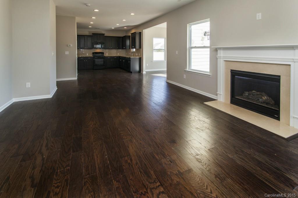 79475 Ridgehaven Road, Unit 43 Lancaster, SC 29720 - Photo 4 of 21 a view of a livingroom with a kitchen and a fireplace