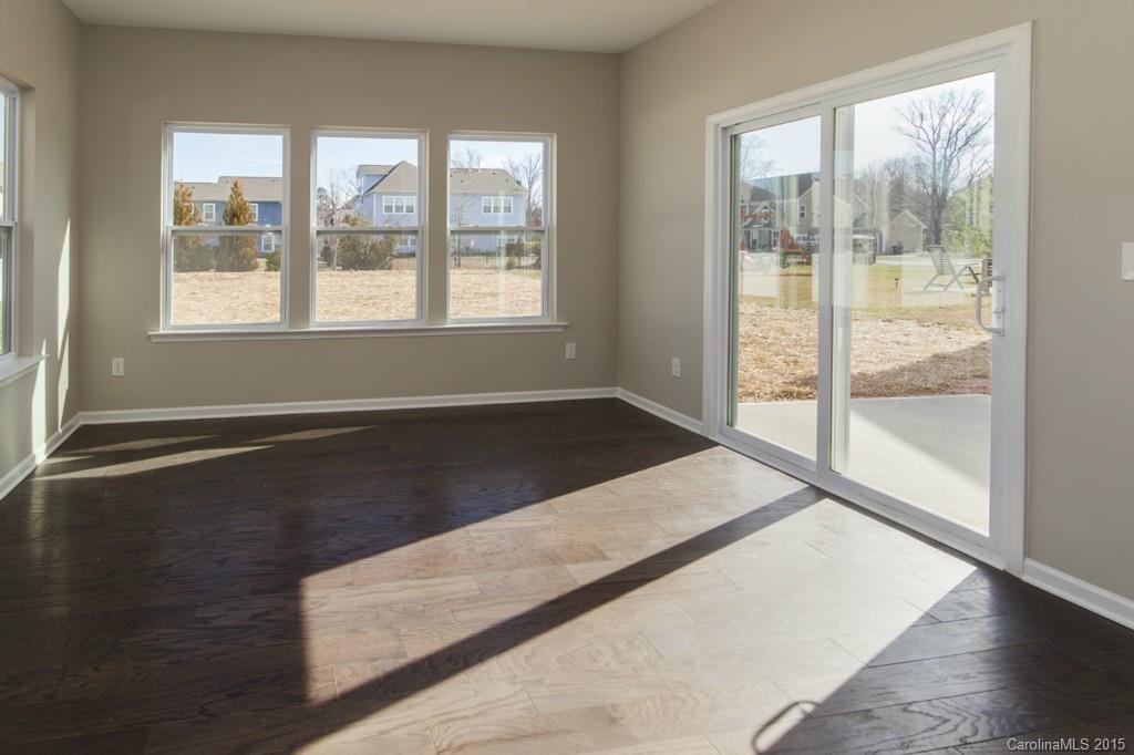 79475 Ridgehaven Road, Unit 43 Lancaster, SC 29720 - Photo 6 of 21 an empty room with wooden floor and windows