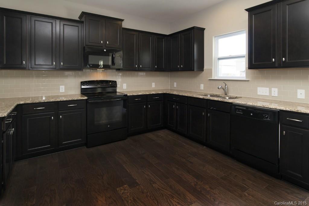 79475 Ridgehaven Road, Unit 43 Lancaster, SC 29720 - Photo 7 of 21 a kitchen with stainless steel appliances granite countertop wooden cabinets granite counter tops and a window