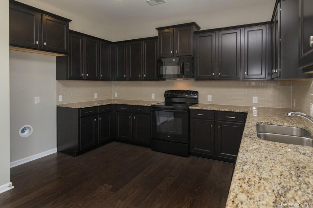 79475 Ridgehaven Road, Unit 43 Lancaster, SC 29720 - Photo 8 of 21 a kitchen with granite countertop wooden cabinets and a granite counter