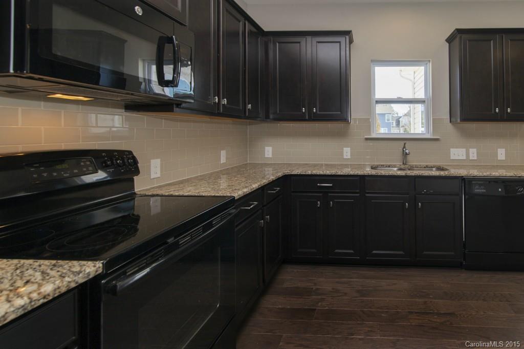 79475 Ridgehaven Road, Unit 43 Lancaster, SC 29720 - Photo 9 of 21 a kitchen with granite countertop a stove and a sink