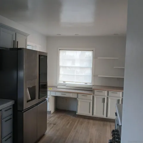 a kitchen with a refrigerator and a sink