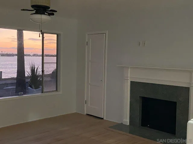 an empty room with windows and a fireplace