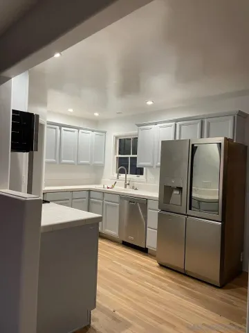 a kitchen with wooden cabinets and stainless steel appliances