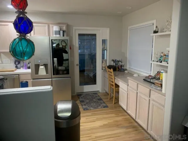 a kitchen with stainless steel appliances kitchen island granite countertop a sink a stove and a wooden floors