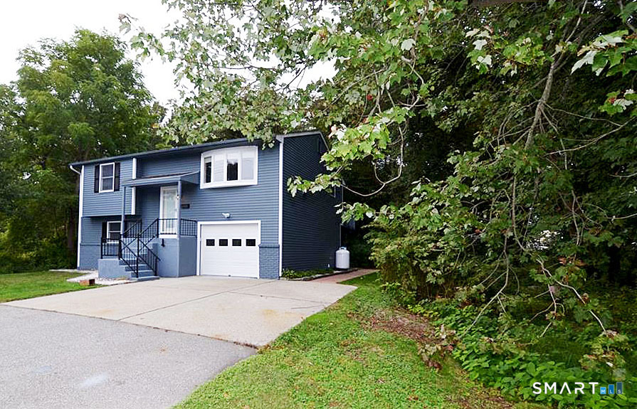 60 Central Boulevard Groton, CT 06340 - Photo 2 of 18 a front view of a house with a yard