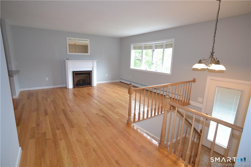 60 Central Boulevard Groton, CT 06340 - Photo 5 of 18 a view of empty room with wooden floor and fan