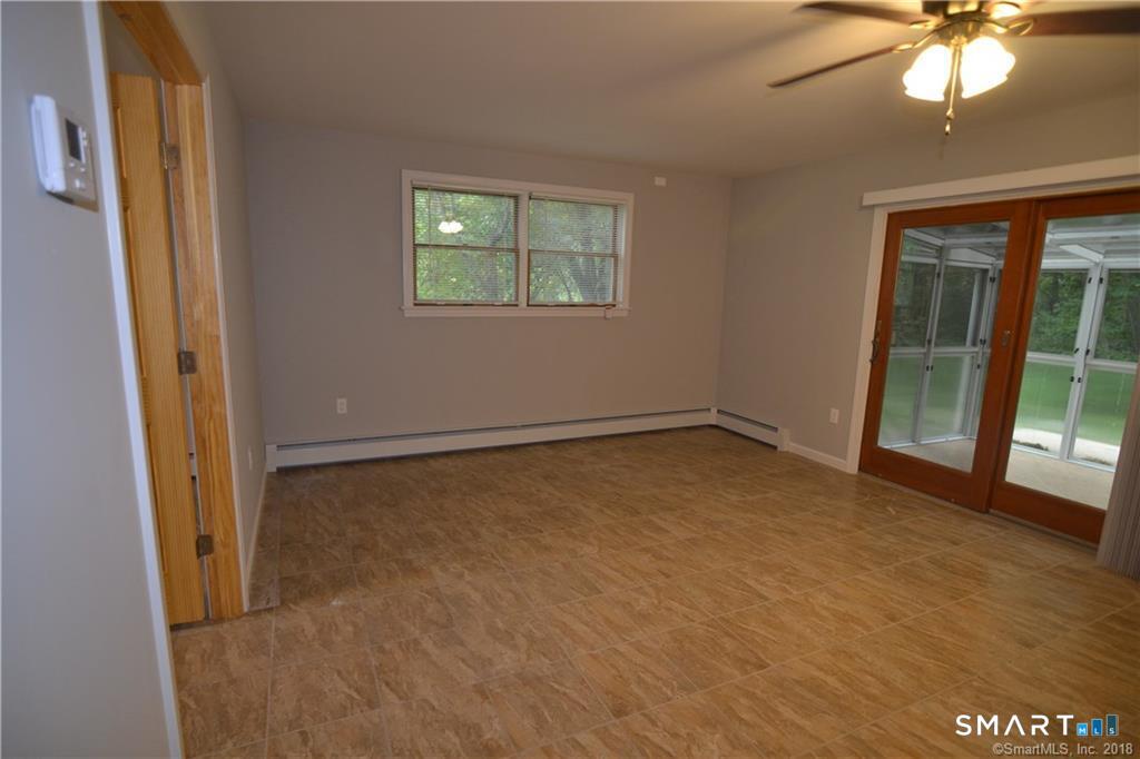 60 Central Boulevard Groton, CT 06340 - Photo 6 of 18 an empty room with windows and entrance