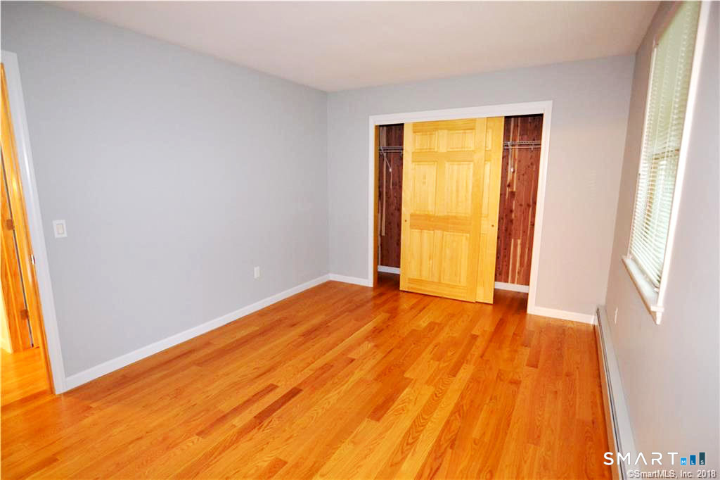 60 Central Boulevard Groton, CT 06340 - Photo 7 of 18 a view of an empty room with wooden floor and a window