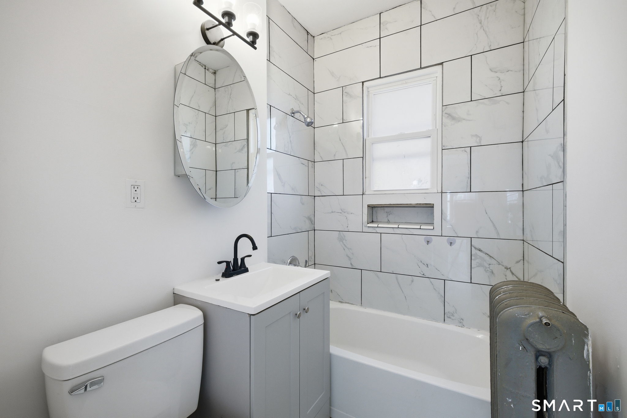 115 Baltimore Street, Unit 2 Hartford, CT 06112 - Photo 7 of 14 a bathroom with a sink a toilet and shower