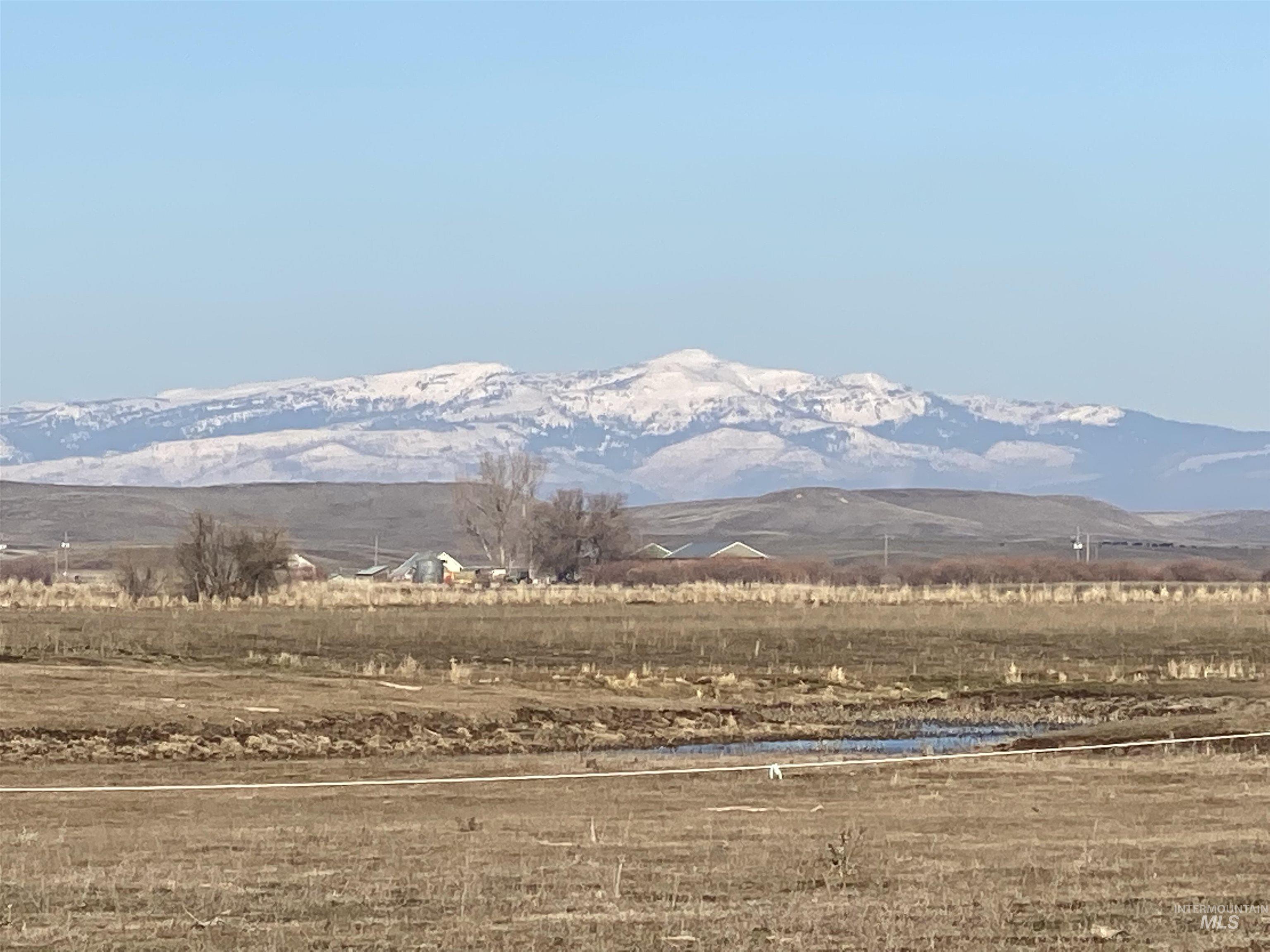 View of mountain backdrop with rural landscape