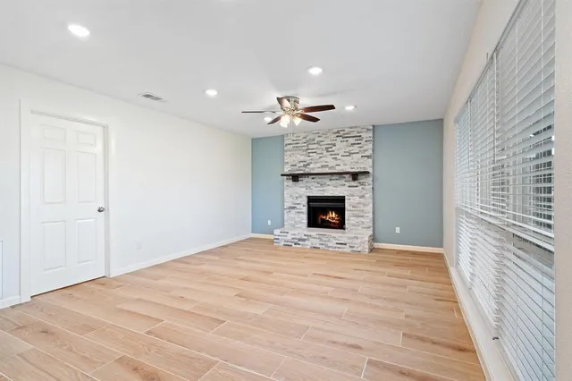 a view of an empty room with a fireplace