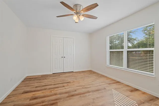 a view of a room with a window and a ceiling fan