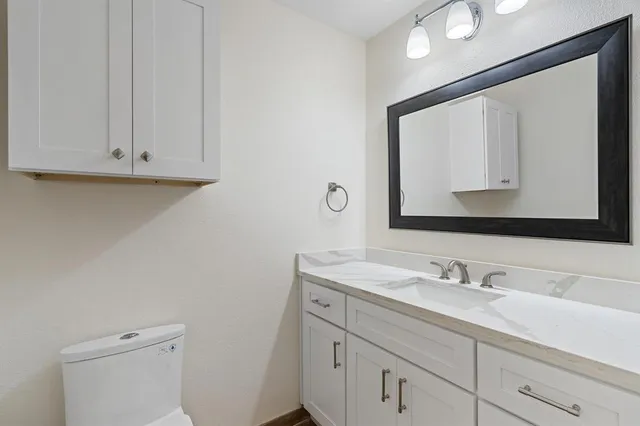 a bathroom with a sink vanity and a mirror
