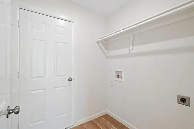 a view of a house with a yard and a large tree