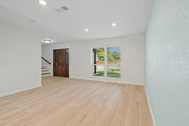 wooden floor in an empty room with a window