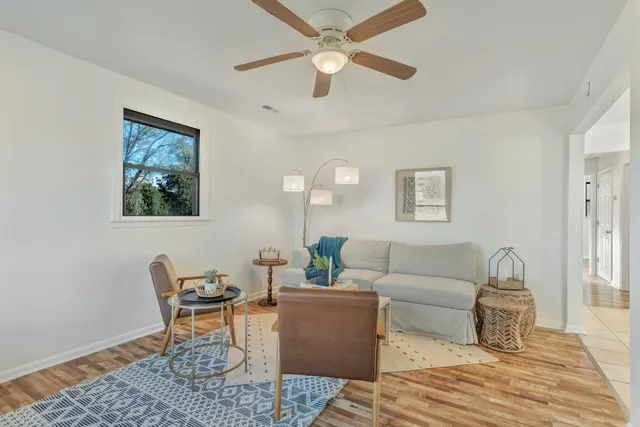 a living room with furniture and a wooden floor