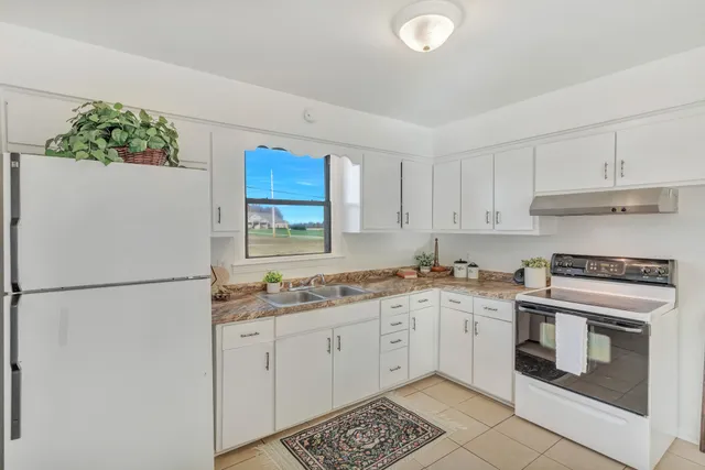 a kitchen with a white cabinets and white appliances