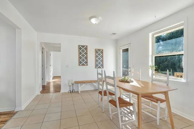 a view of a dining room with furniture and window