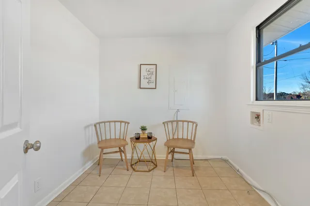 a view of a room with furniture and windows