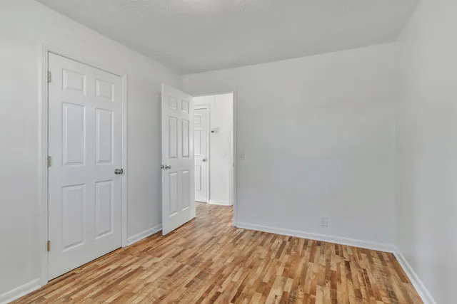 a view of room with wooden floor