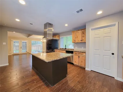 a kitchen with granite countertop a stove and a sink