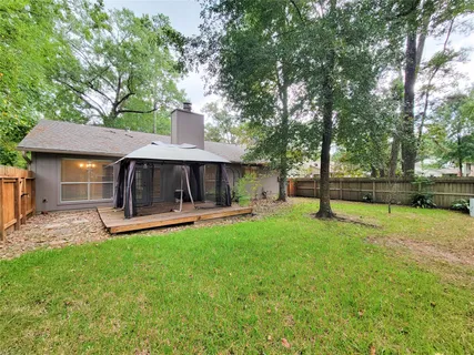 a view of a house with a yard and sitting area
