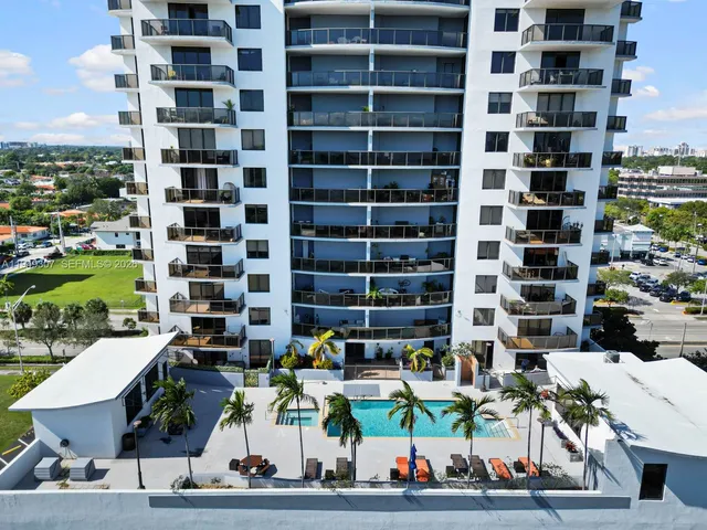 a view of a patio with couches and table and chairs with wooden fence