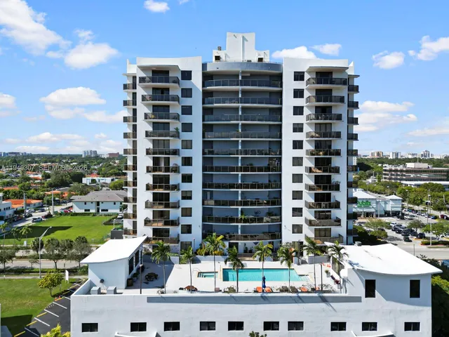 a front view of multi story residential apartment building with yard