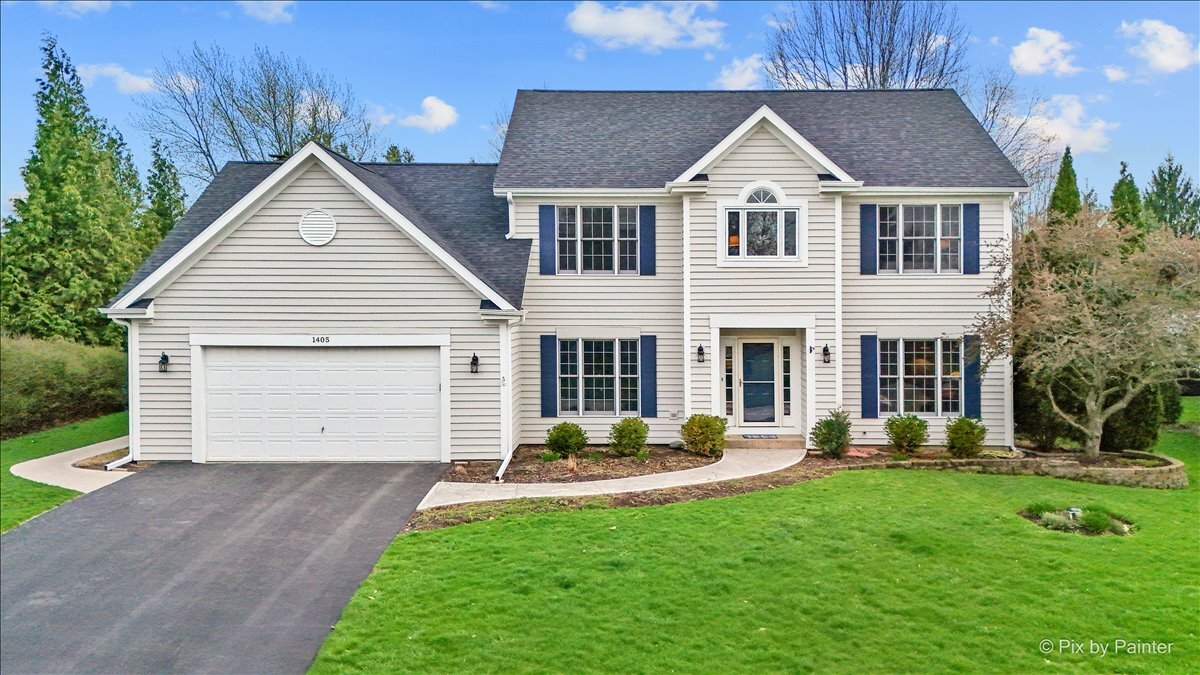 1405 Elk Trail Cary, IL 60013 - Photo 1 of 39 a front view of a house with a yard and garage
