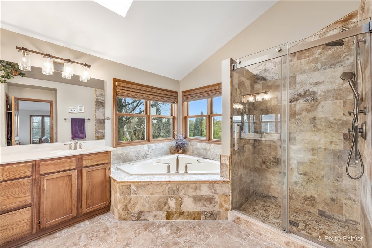 1405 Elk Trail Cary, IL 60013 - Photo 16 of 39 a spacious bathroom with a tub sink and mirror
