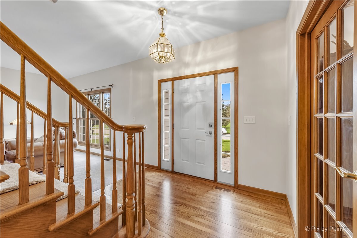 1405 Elk Trail Cary, IL 60013 - Photo 2 of 39 a view of an entryway with hardwood floor and interior