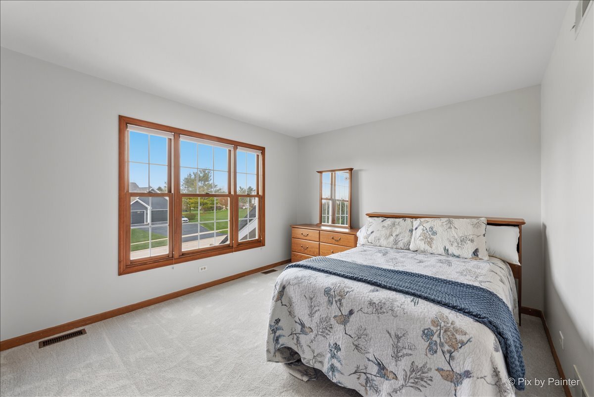 1405 Elk Trail Cary, IL 60013 - Photo 8 of 39 a bed sitting in a bedroom next to a window