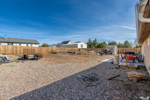 348 North Lodge Road Central, UT 84722 - Photo 16 of 25 Fenced backyard featuring a shed and a patio