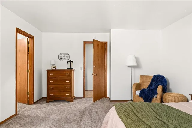 a spacious bathroom with a double vanity sink a large mirror and a bathtub