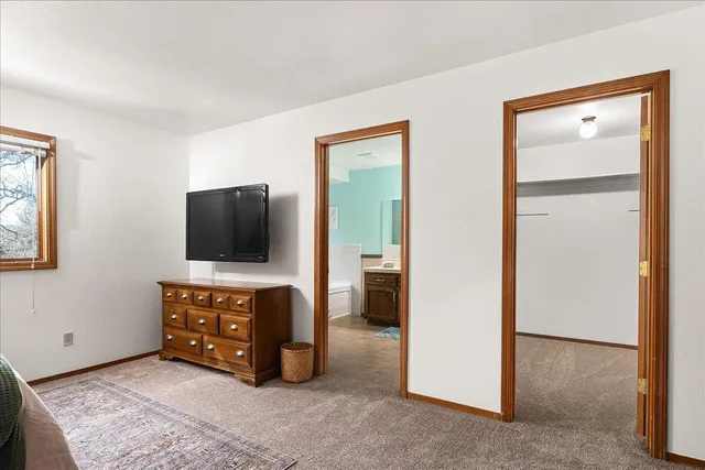 a bathroom with a bathtub and next to a window