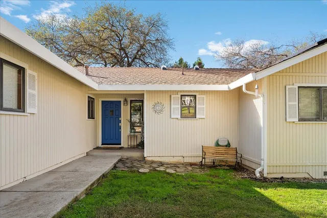 a living room with furniture and large windows