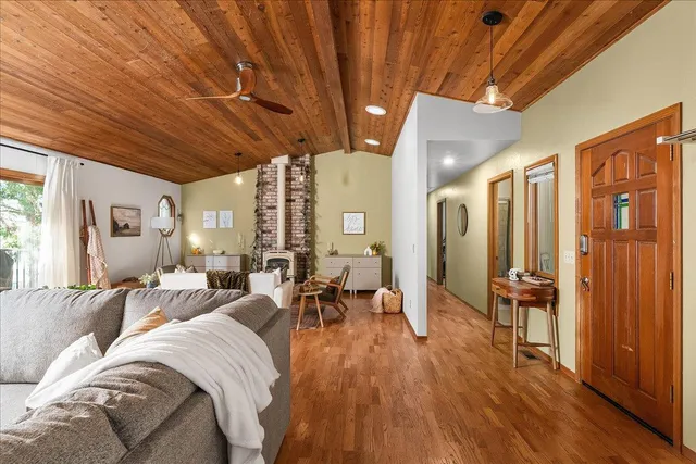 a living room with furniture flowerpot and wooden floor