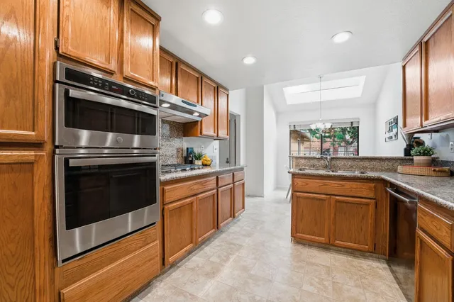 a view of a dining room with furniture and chandelier
