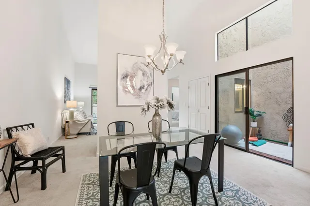 a view of a dining room with furniture and chandelier